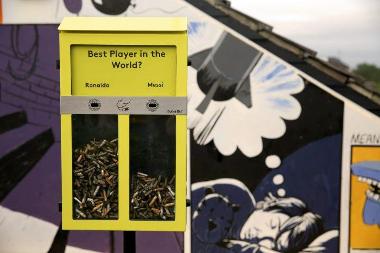 A ballot bin, which encourages smokers to use their stubs to vote on a general topic, such as who is the best footballer, rather than throw them on the ground.