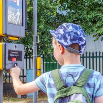 Child waiting to cross a road