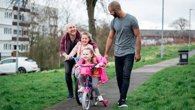 Two men and two young children cycling