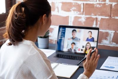 Person with a laptop open taking part in an online meeting