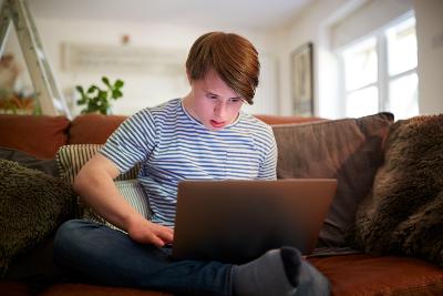 Photograph of a person using a laptop