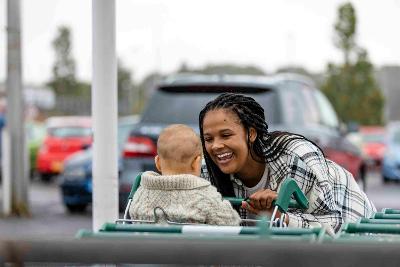 Parent with child in shopping trolley