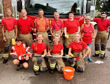 A group of Stalham firefighters posing with a fire engine