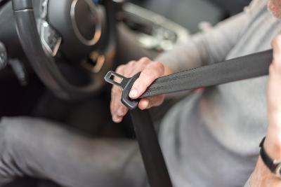 Driver putting on seatbelt