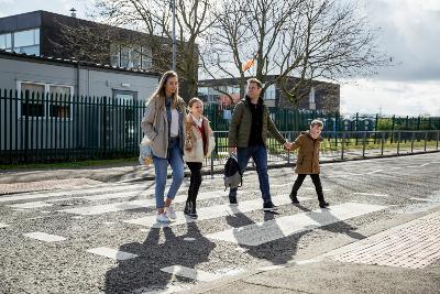 Family using zebra crossing