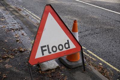 Flood warning road sign on a residential road